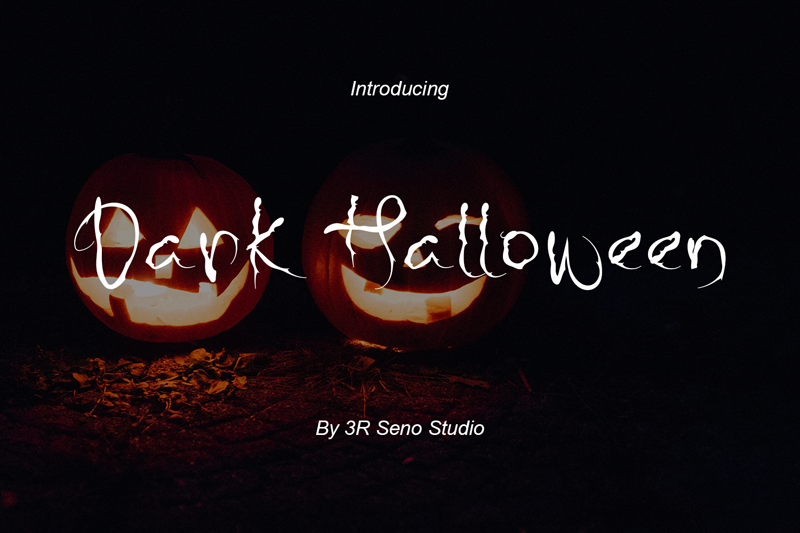 Two glowing jack-o'-lanterns illuminate the "Dark Halloween" text, crafted with a free Halloween font, against a shadowy backdrop.