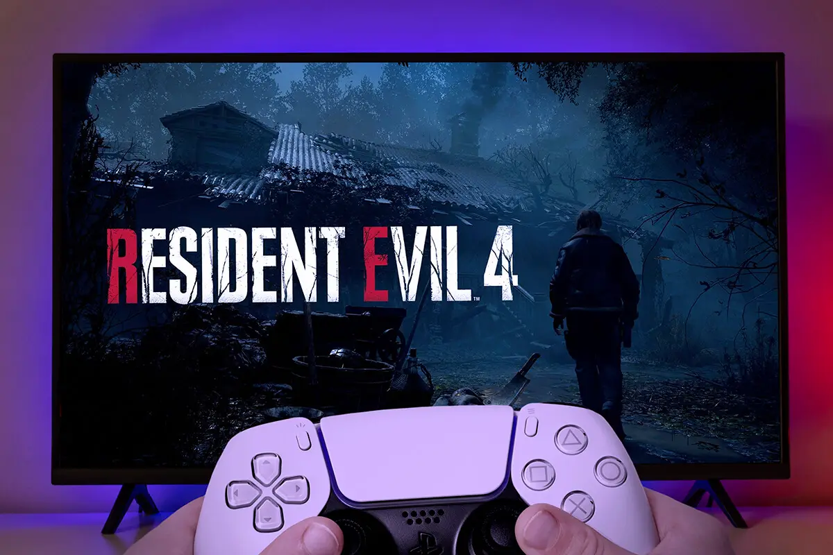 Man playing Resident Evil 4 Remake with Playstation controller on TV.