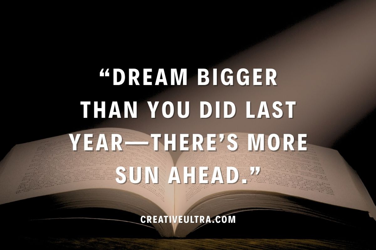 Open book with a spotlight on it, displaying the quote, "Dream bigger than you did last year—there’s more sun ahead." The tone is inspiring and hopeful.