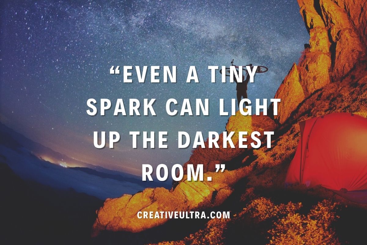 Starry night sky above a person on a rocky hill with a red tent; inspiring quote reads, "Even a tiny spark can light up the darkest room."