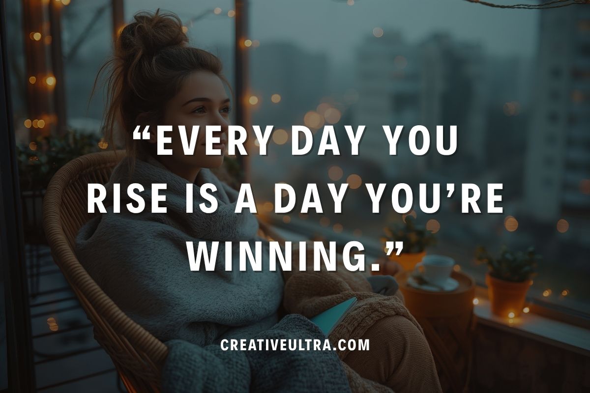 A woman wrapped in a cozy blanket sits on a balcony chair, gazing outside with warm lights and plants nearby. Bold text reads, "Every day you rise is a day you're winning." Calm, contemplative atmosphere.