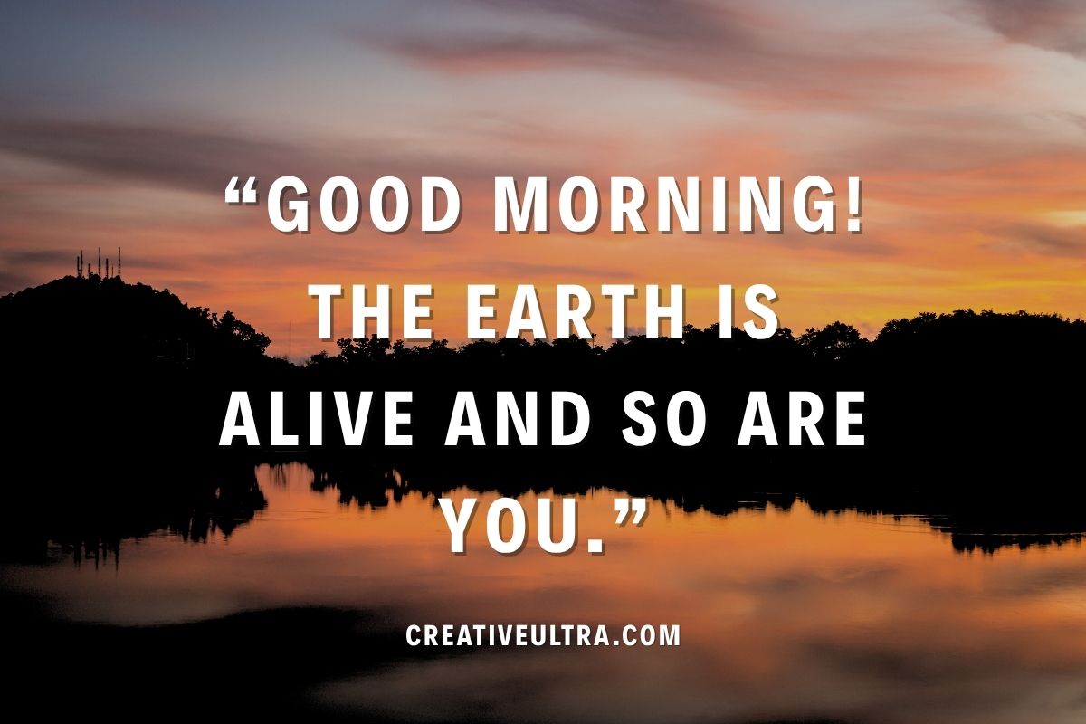 Sunset sky over a calm lake with silhouetted trees. Overlay text reads: "Good morning! The Earth is alive and so are you." Calming and inspirational tone.