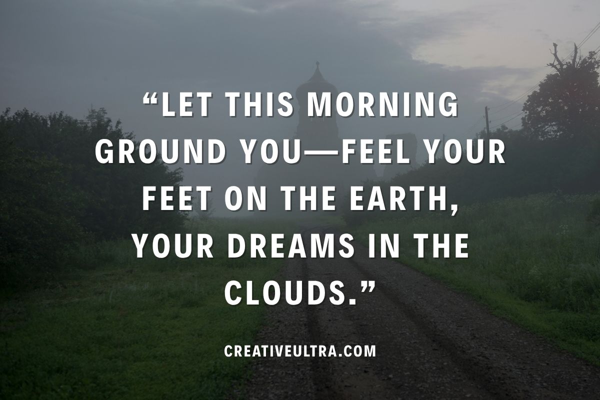 Misty morning landscape with trees lining a dirt path, sky suggestive of sunrise. Overlaid text: "Let this morning ground you—feel your feet on the earth, your dreams in the clouds." Calm, reflective mood.